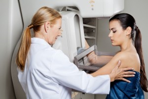 doctor gives woman a mammogram