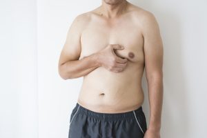 Man holding his male breast