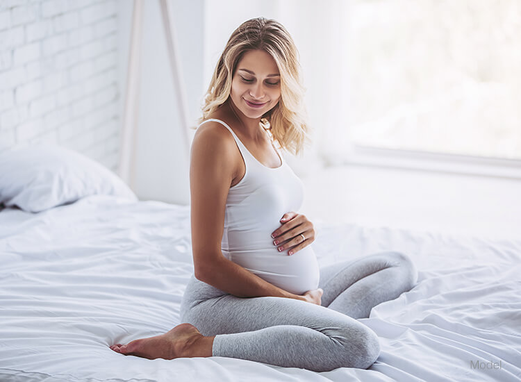 Pregnant woman holding her belly