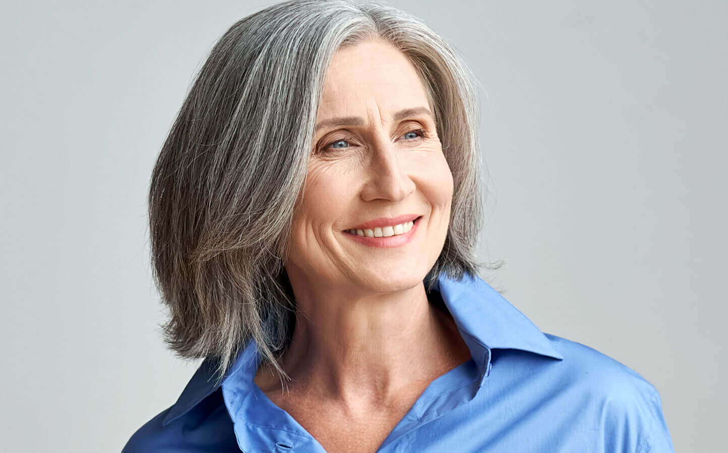 happy middle aged woman in a blue blouse