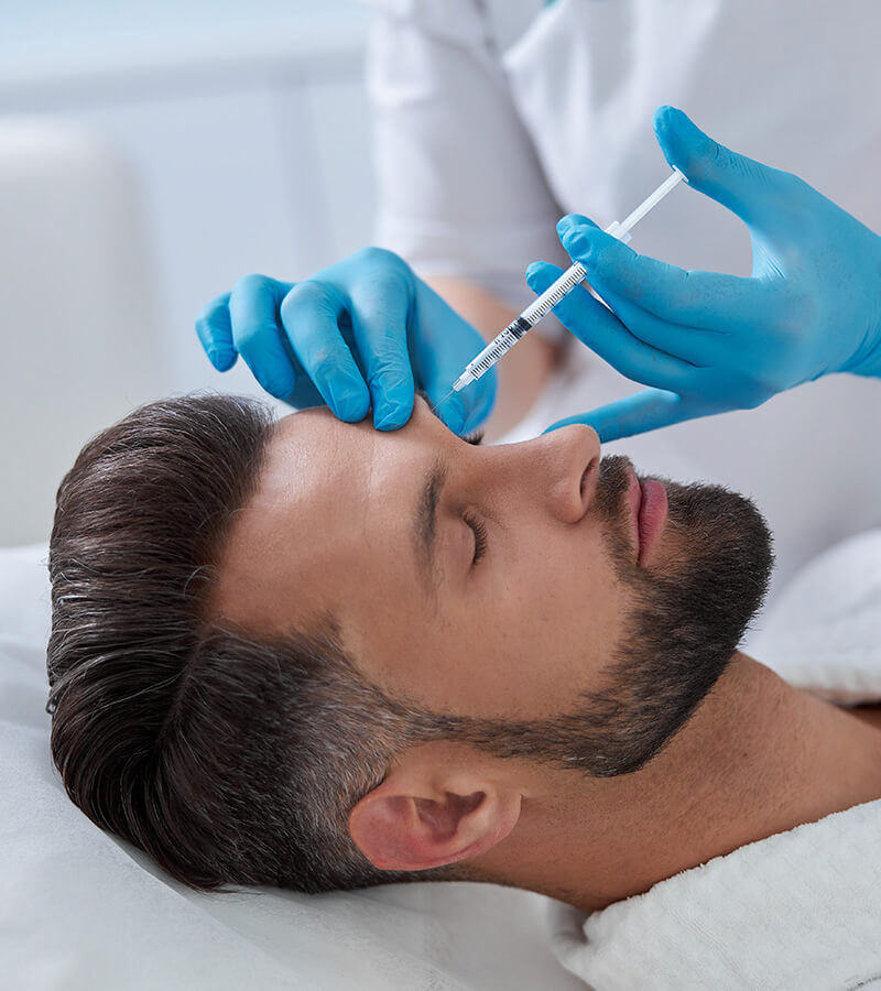 Handsome man getting facial injections