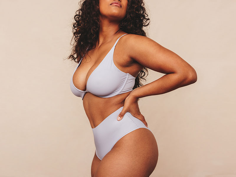 Curvy woman in undergarments holding her hands on her hips