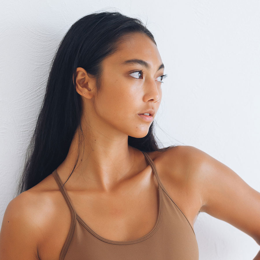 Asian young women of color in a brown spaghetti strap blouse