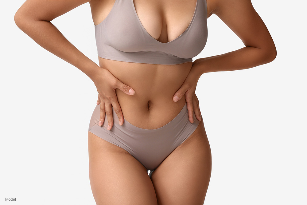 Curvy woman in gray underwear with her hands on her hips